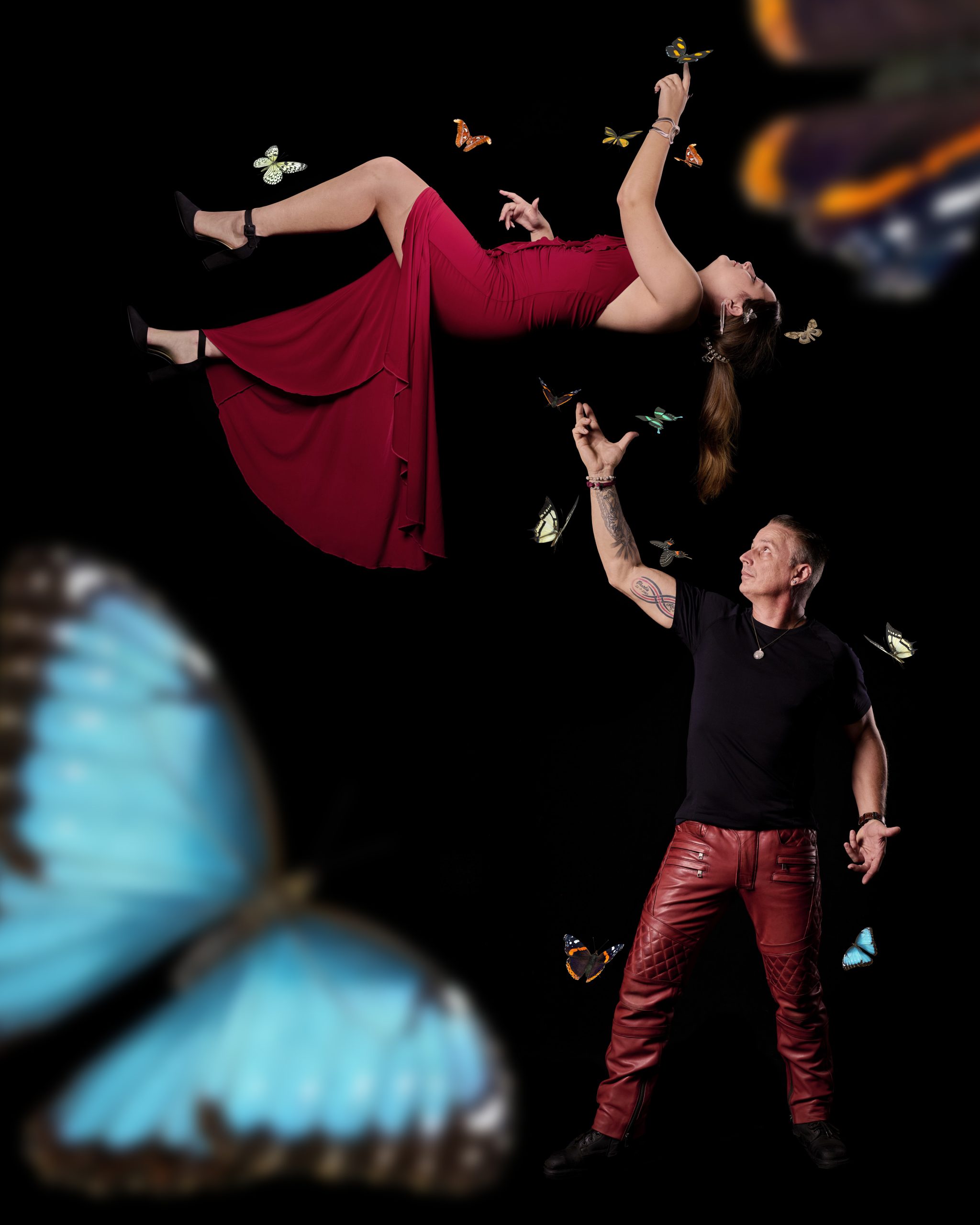 This image captures a signature illusion where Dr. Ace levitates an assistant, surrounded by butterflies, evoking a magical atmosphere. The purpose is to inspire wonder and invite viewers to suspend their disbelief, showcasing the essence of the impossible